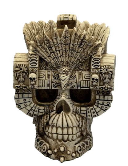 Front view of Aztec Montezuma skull statue with feathered headdress and intricate tribal carvings in bone finish
