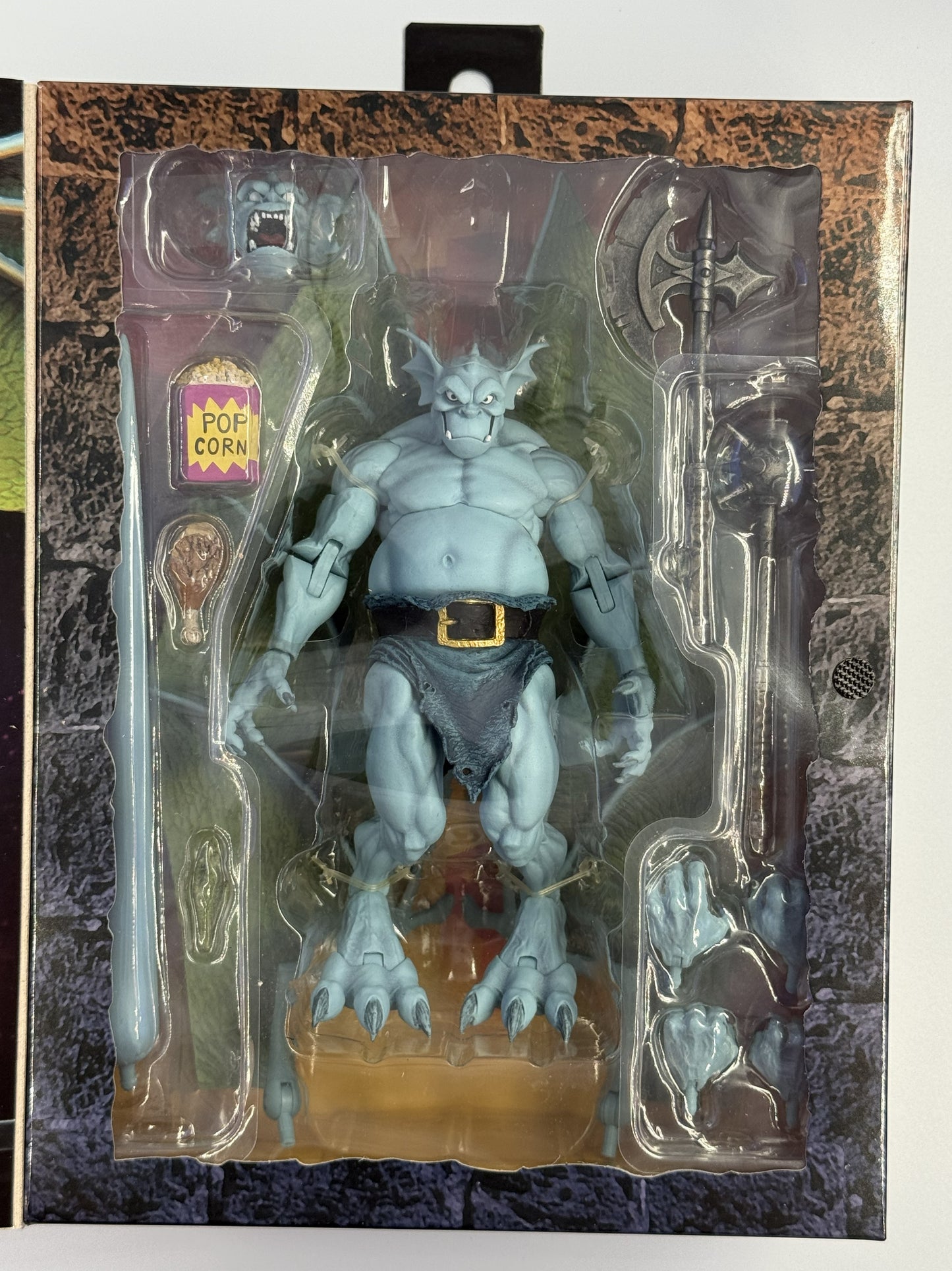 NECA Gargoyles Broadway figure inside packaging with accessories and interchangeable parts
