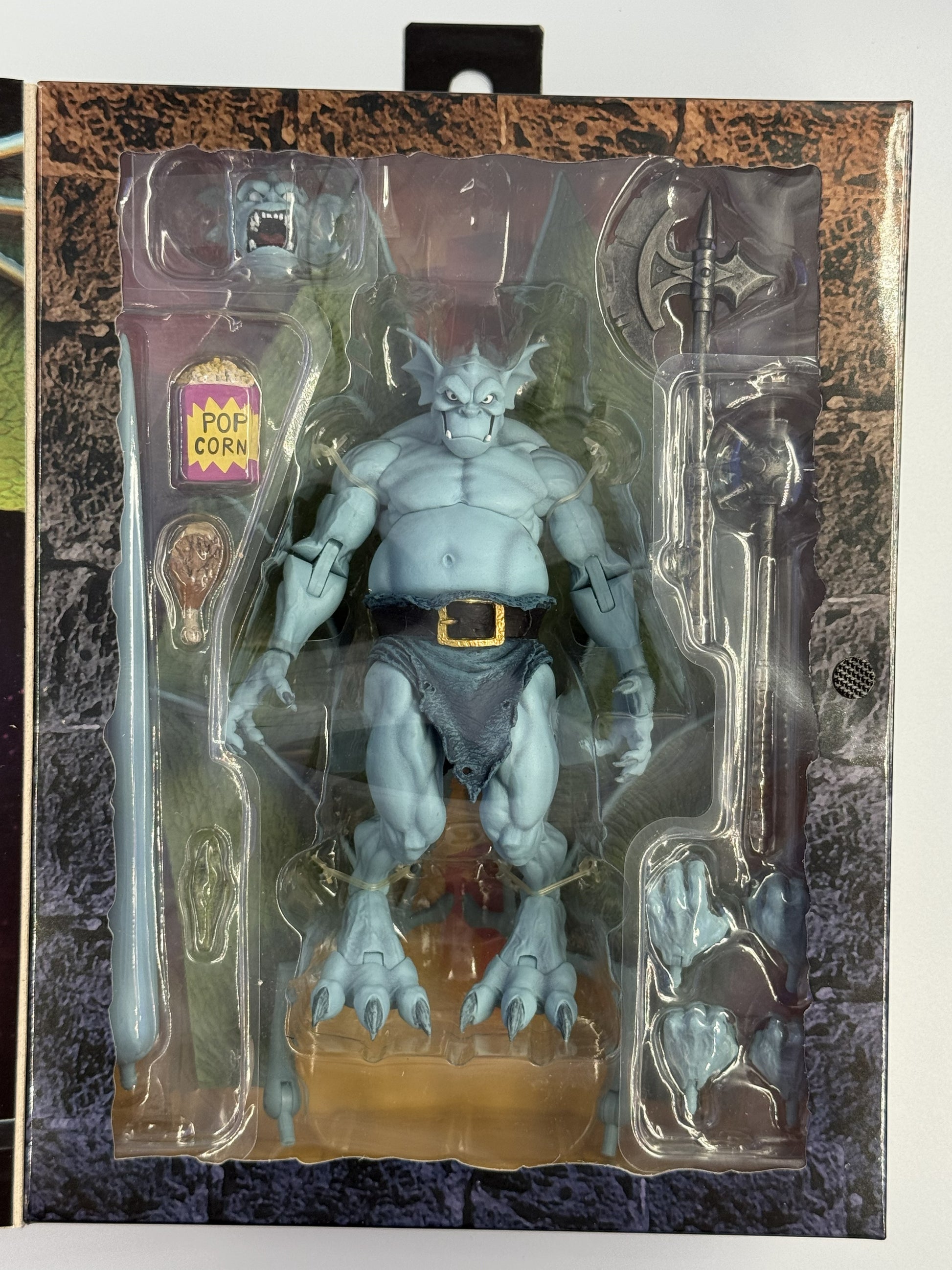 NECA Gargoyles Broadway figure inside packaging with accessories and interchangeable parts
