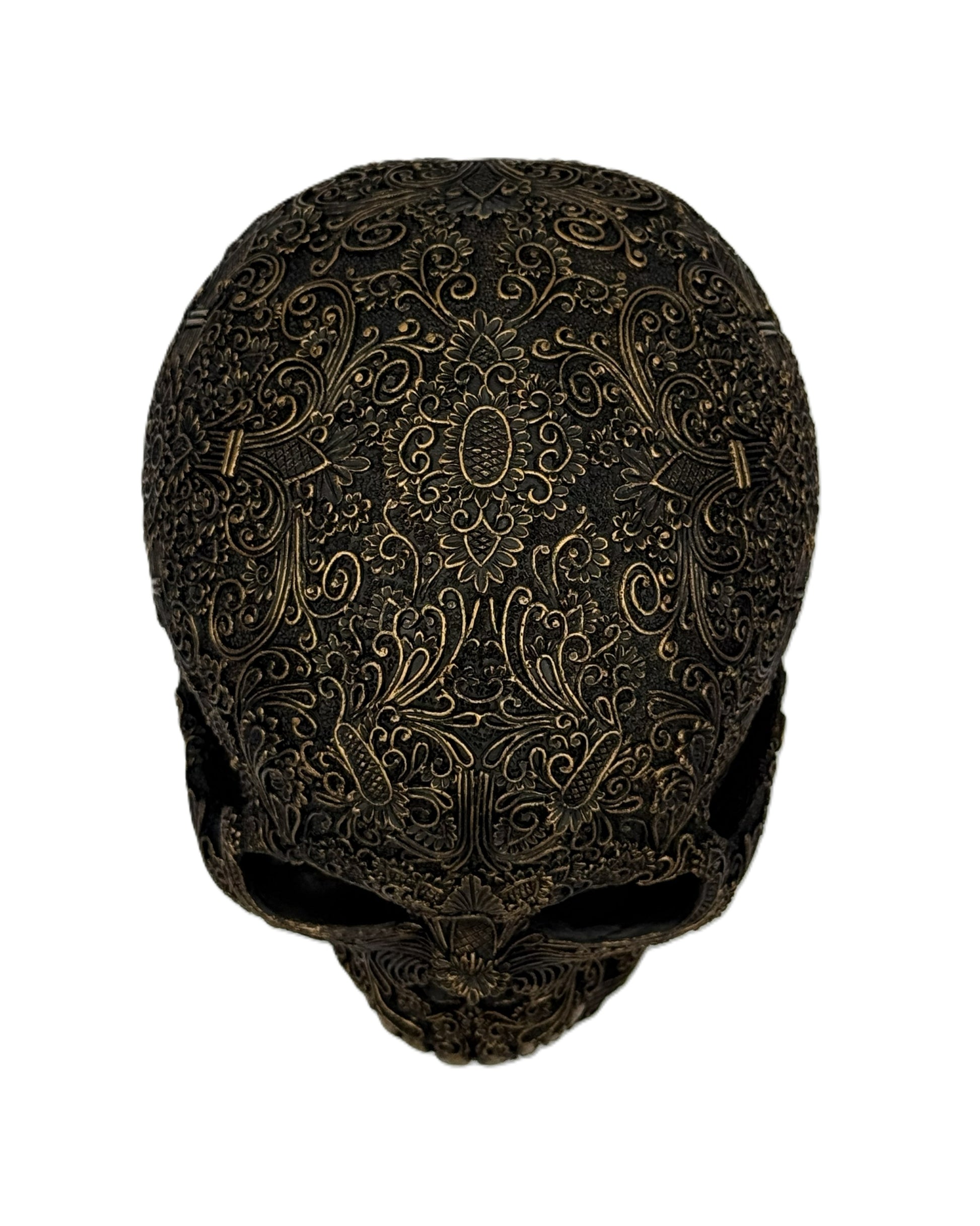 Straight front view of ornate gothic skull sculpture with symmetrical engraved design and aged finish
