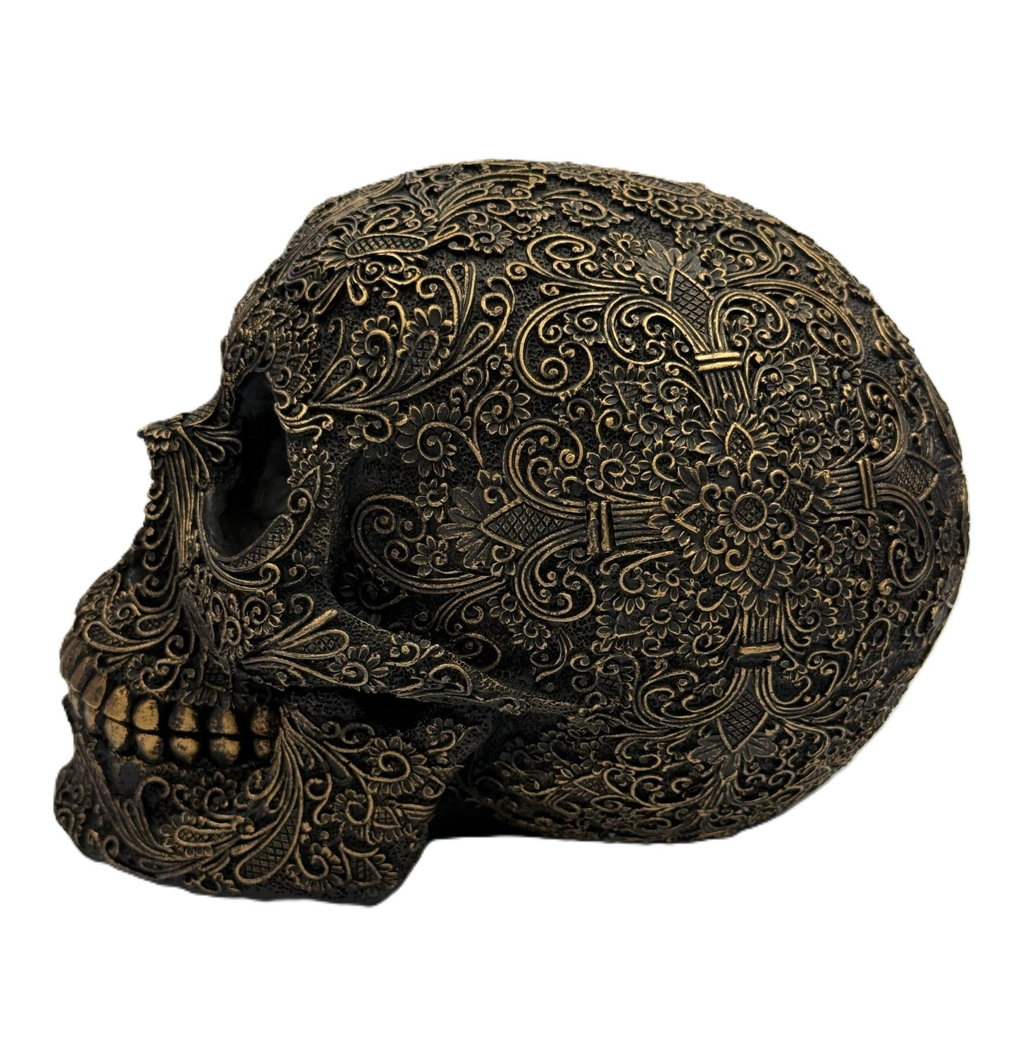 Front angled view of ornate carved gothic skull sculpture with intricate floral patterns and antique bronze finish
