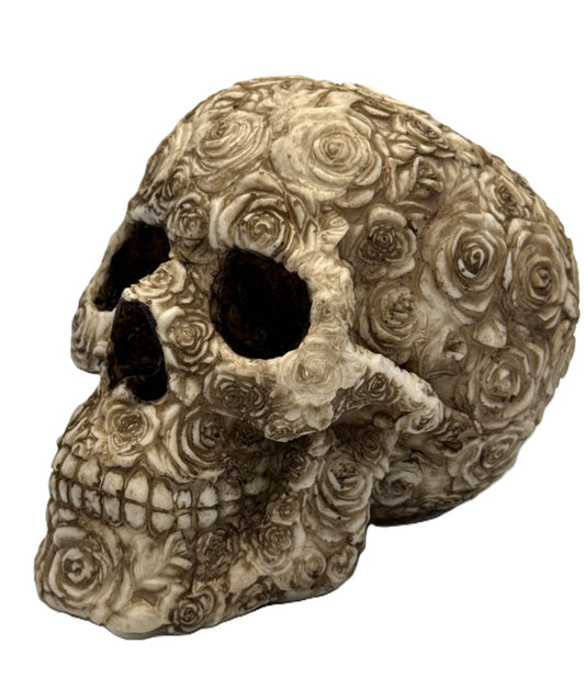 Front left angled view of rose skull resin statue with detailed floral carvings and gothic bone finish
