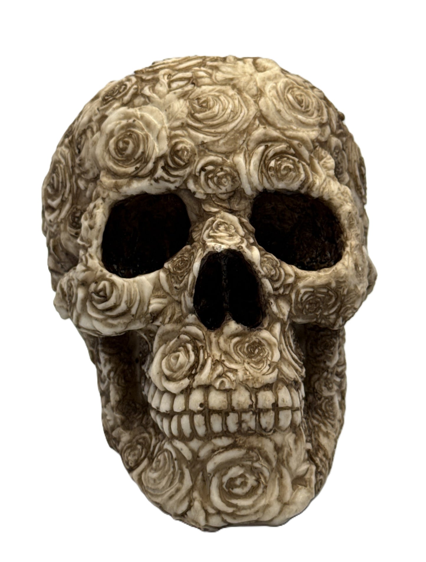 Front view of floral skull statue with hollow eyes and detailed rose embellishments in gothic style
