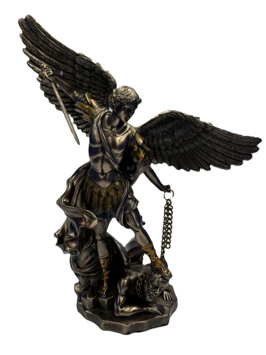 Front view of Saint Michael Archangel bronze statue with sword raised defeating demon

