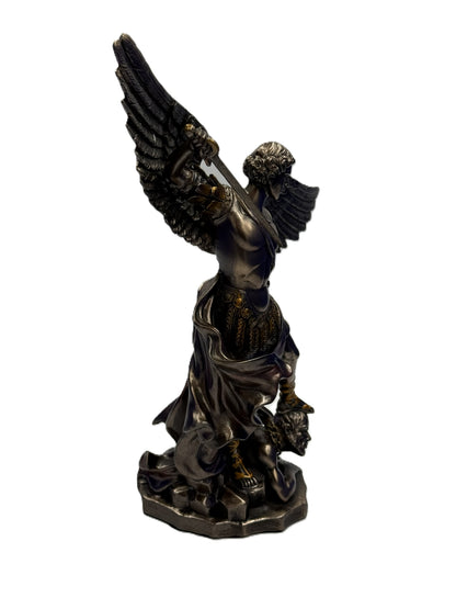 Rear angle view of Saint Michael statue emphasizing sculpted wings and stance
