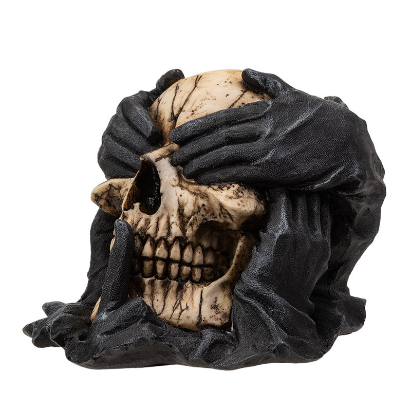 Angled view showcasing depth and contrast between hands and skull
