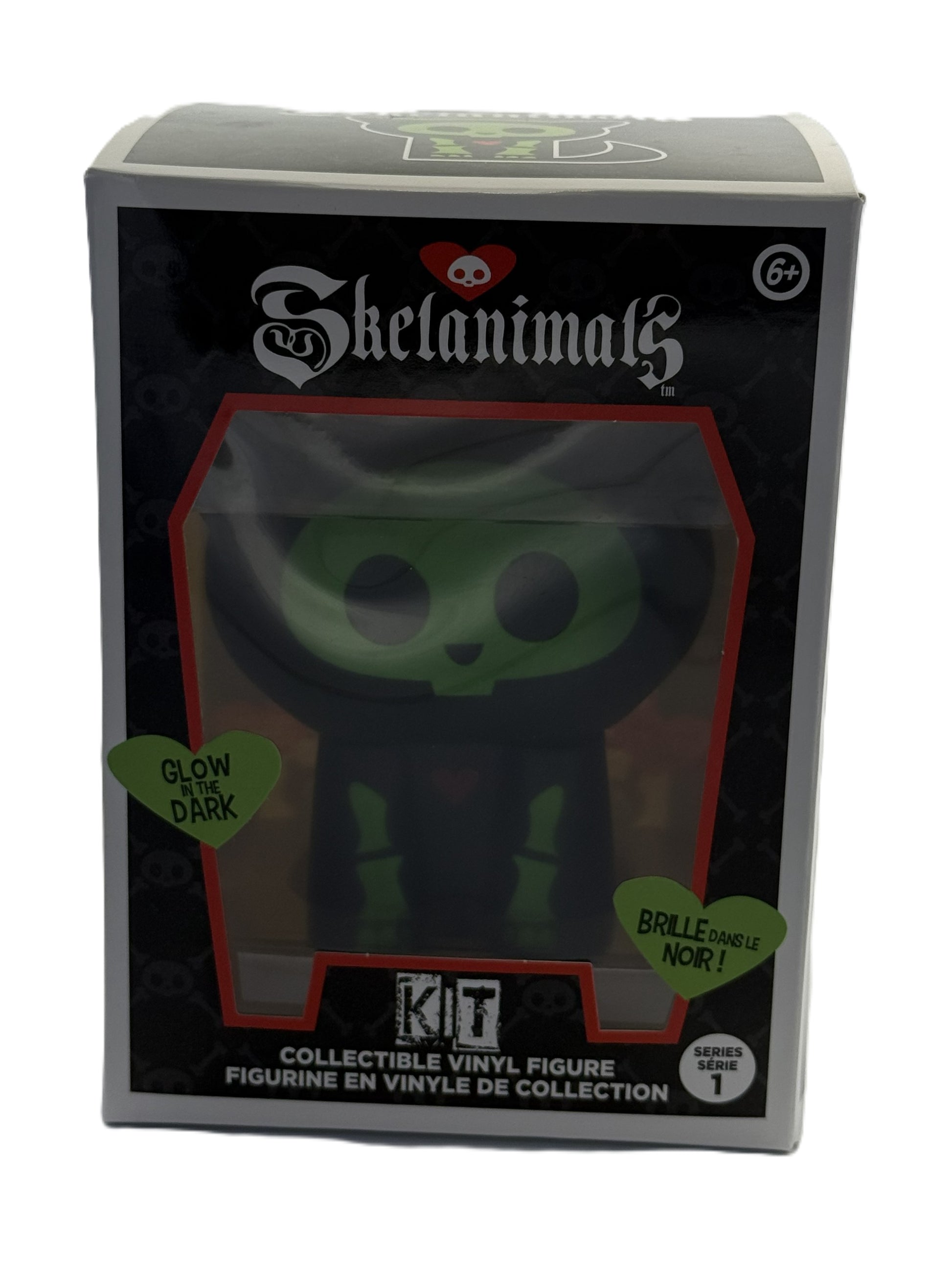 Front view of Skelanimals Kit vinyl figure packaging showing glow in the dark cat design inside window box
