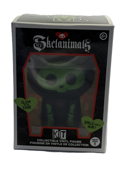Front view of Skelanimals Kit vinyl figure packaging showing glow in the dark cat design inside window box
