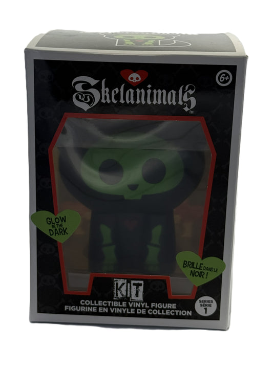 Front view of Skelanimals Kit vinyl figure packaging showing glow in the dark cat design inside window box
