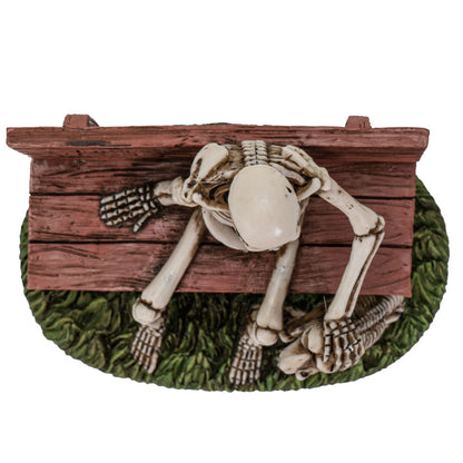 Top view showing skeleton seated on bench with detailed sculpting and textured base
