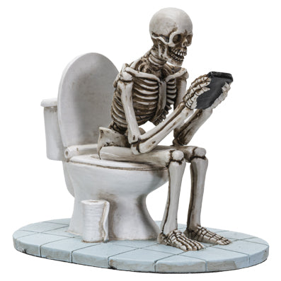 Alternate front view showing toilet base, tile flooring, and skeleton holding reading material
