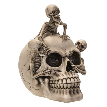 Angled view showing all three skeleton figures interacting with skull design
