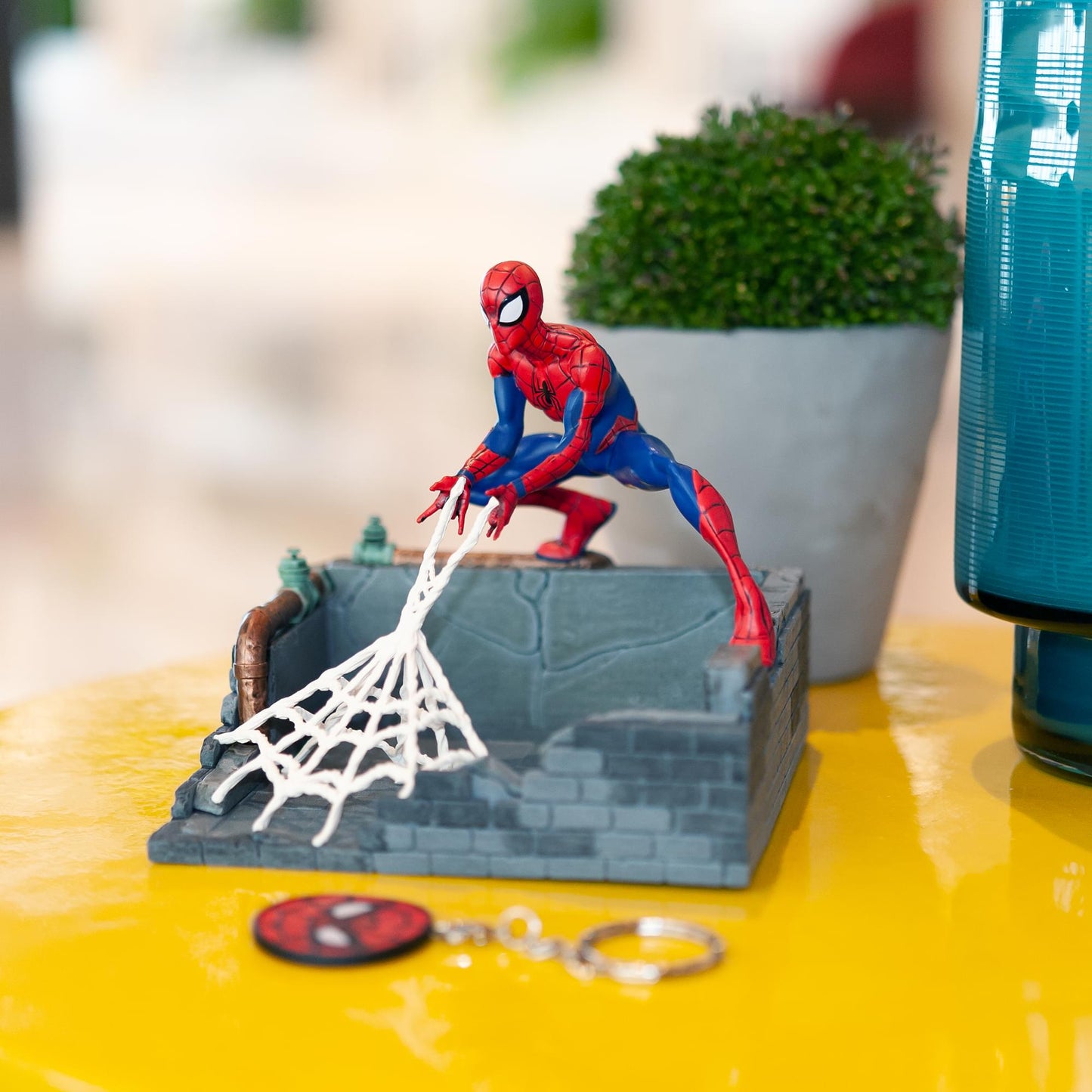 angled view of Spider-Man finders keyper statue on display with keychain
