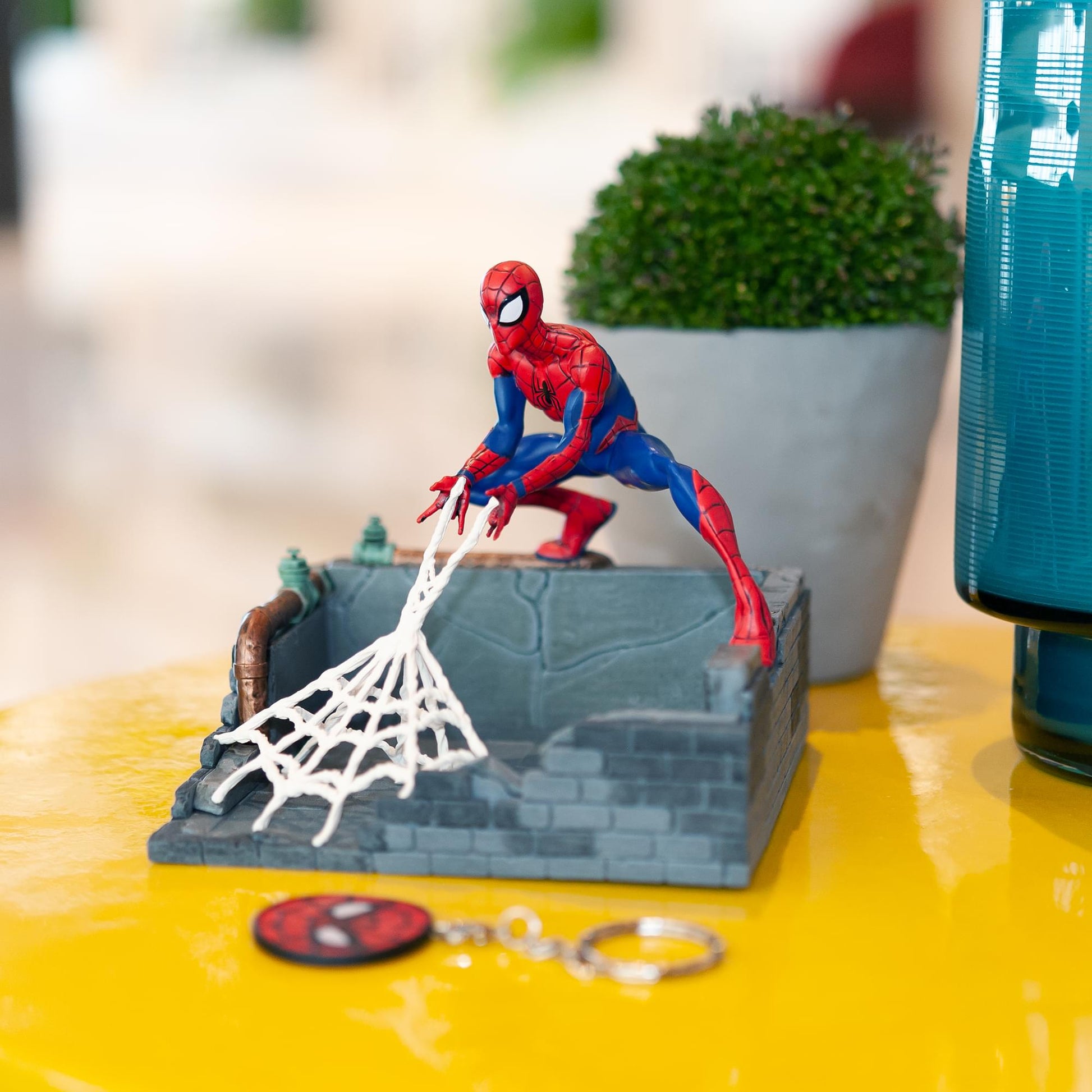 angled view of Spider-Man finders keyper statue on display with keychain
