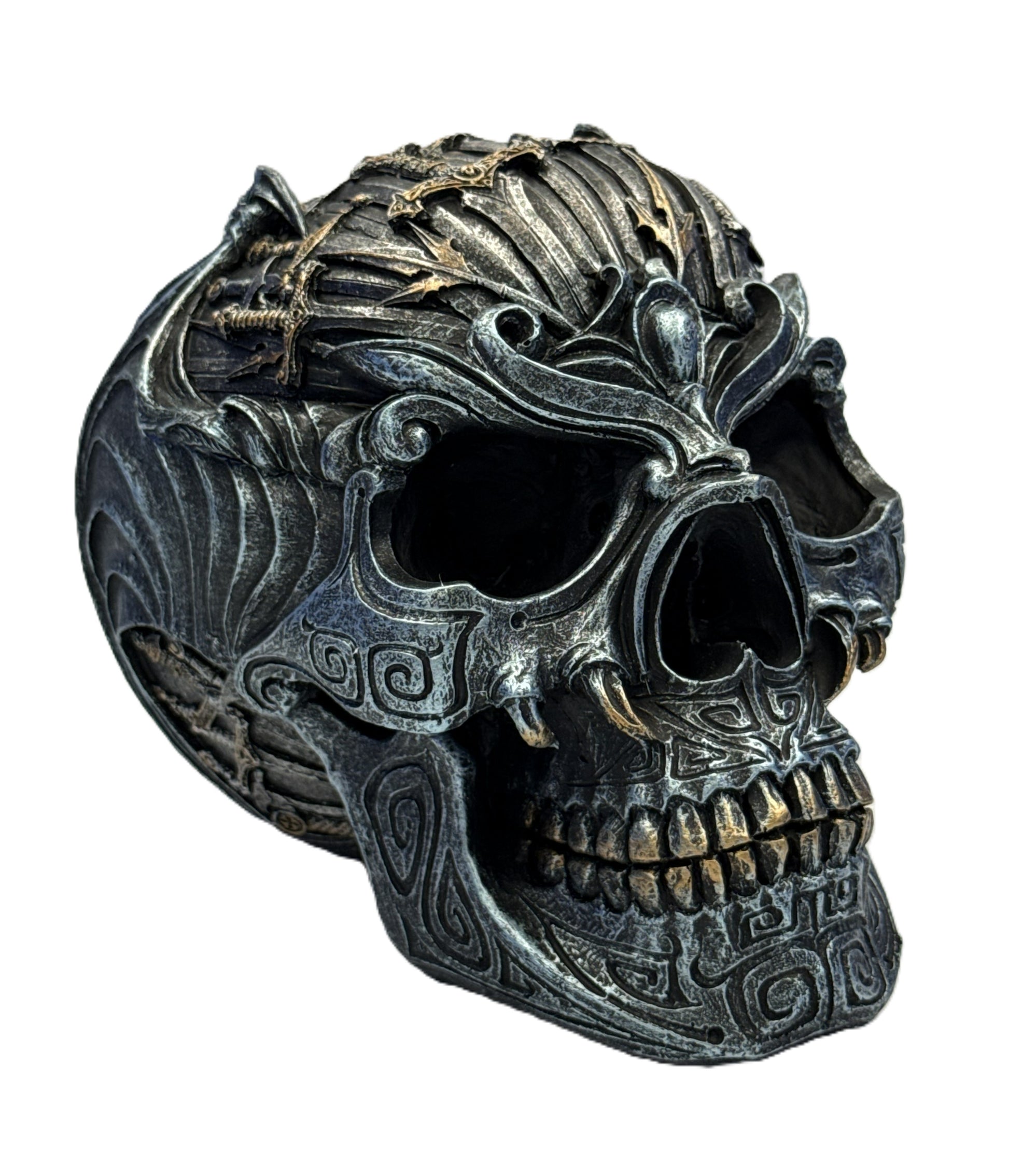 Front right angle of skull statue with ornate facial engravings and metallic sword accents
