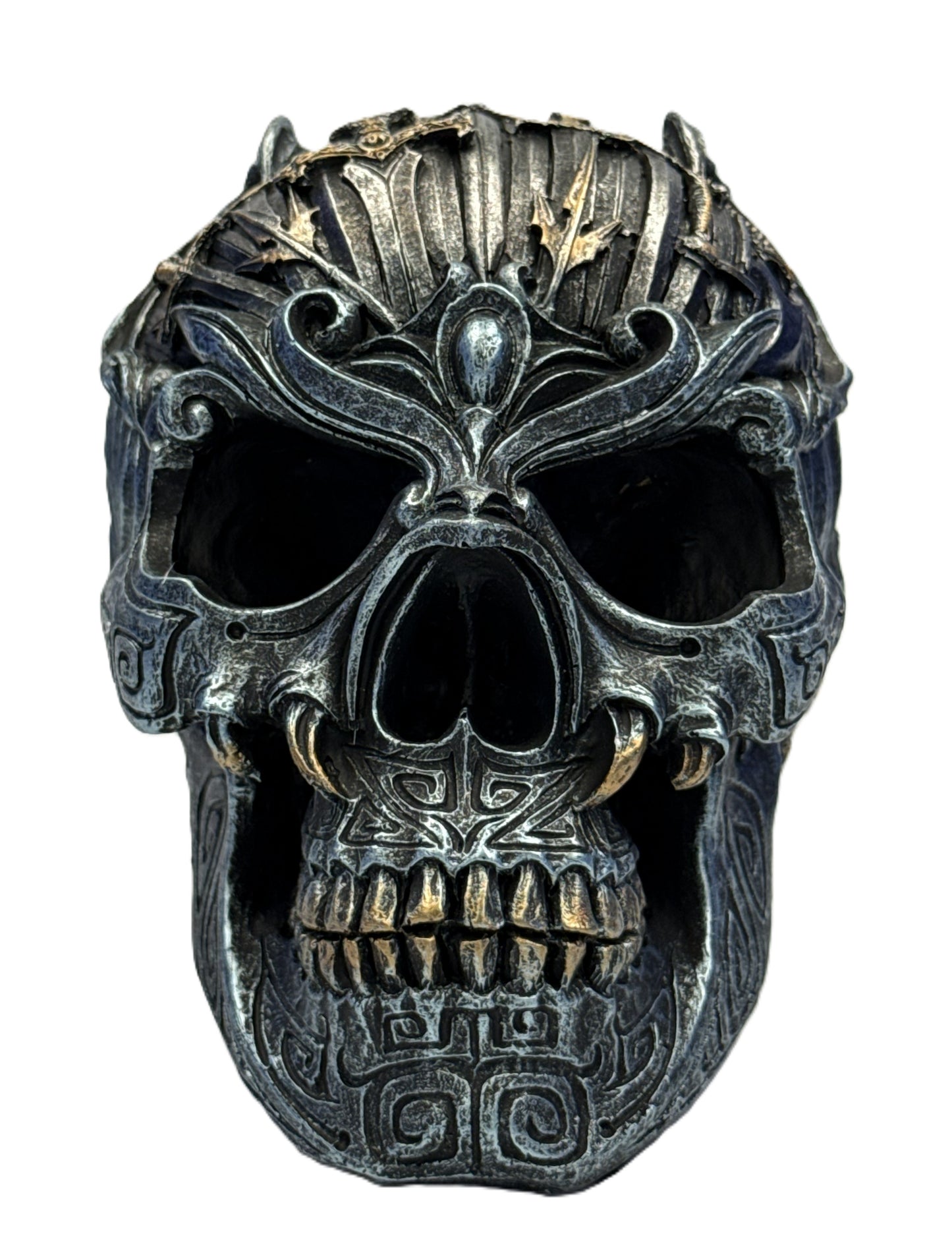 Front view of gothic skull sculpture featuring symmetrical carvings and aged metallic finish
