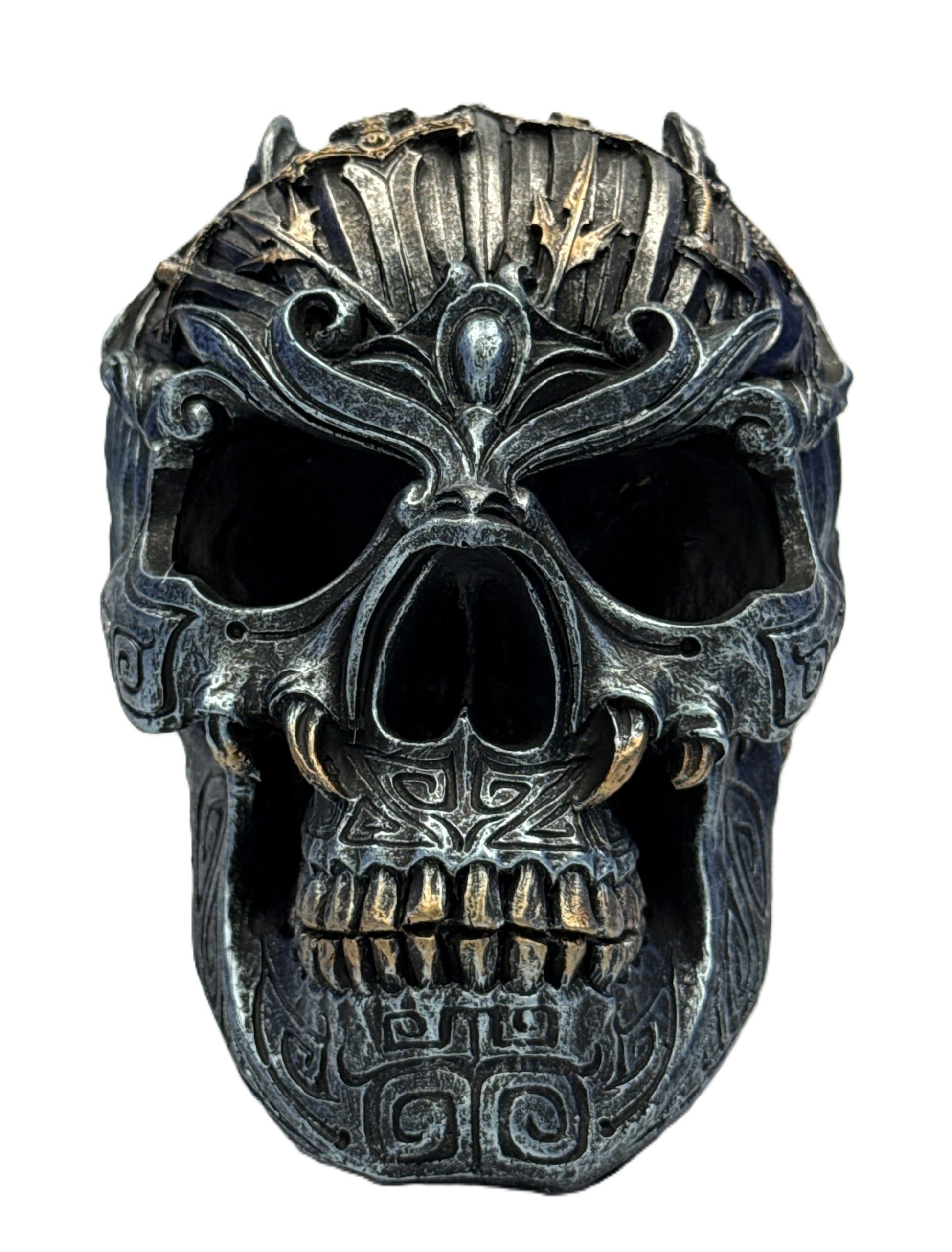 Front view of gothic skull sculpture featuring symmetrical carvings and aged metallic finish
