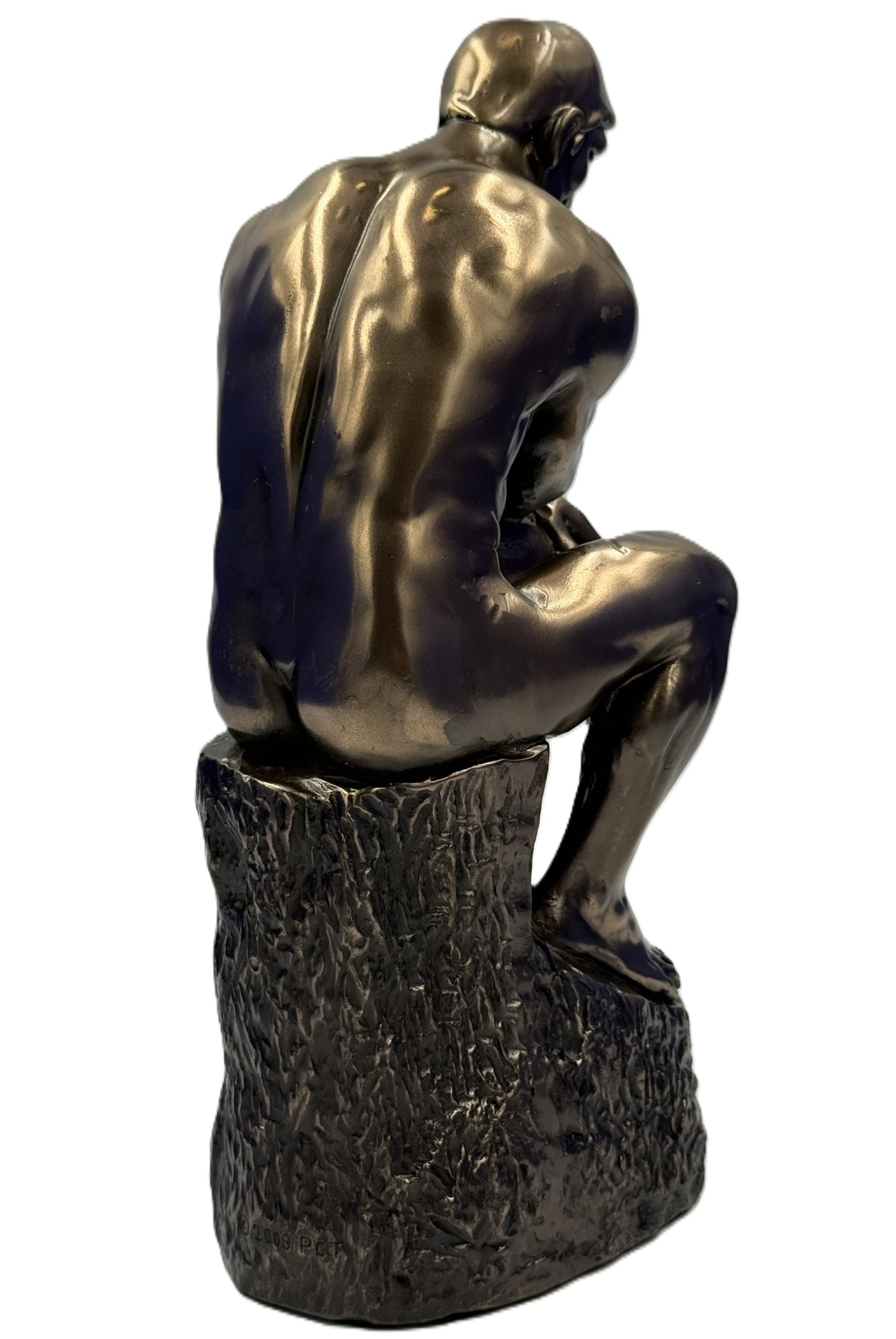 Rear view of The Thinker statue showing muscular back detail and bronze finish
