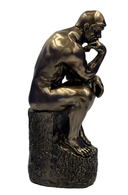 Side profile of The Thinker statue emphasizing anatomical detail and seated posture on textured base
