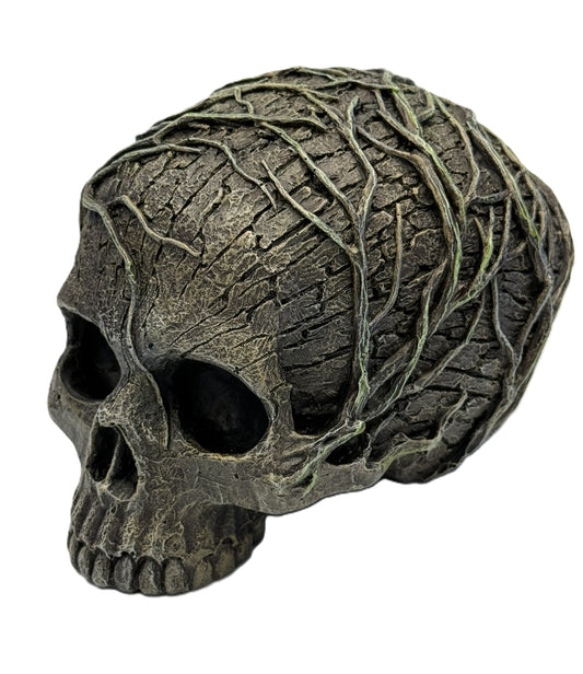 Front angled view of tree spirit skull statue with vine-covered textured surface and hollow eyes in gothic nature design
