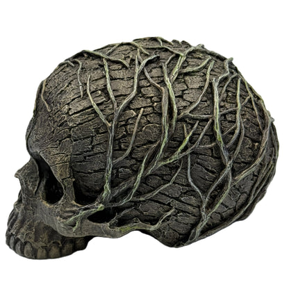 Left side view of skull statue featuring detailed bark texture and creeping vines wrapping across the surface
