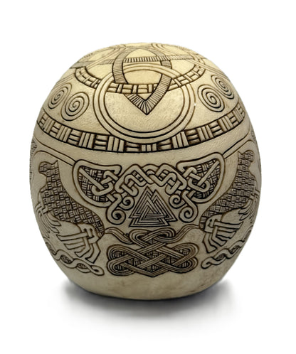 Back view of Viking skull statue featuring Odin ravens and Celtic knot engravings on resin surface
