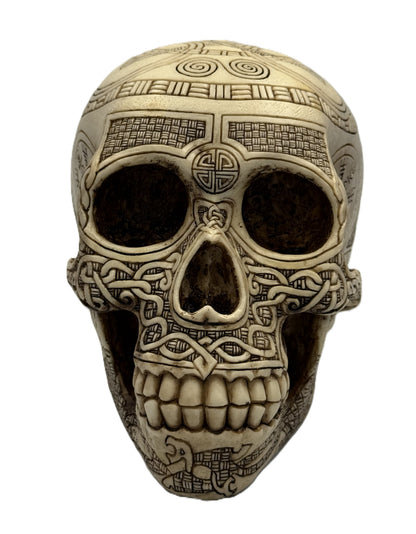 Front view of Viking skull statue with detailed teeth carving and symmetrical knotwork patterns
