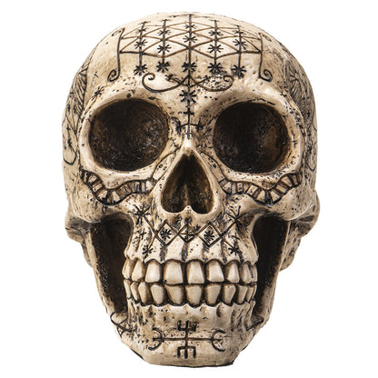 Voodoo skull statue front view with intricate occult symbol engravings
