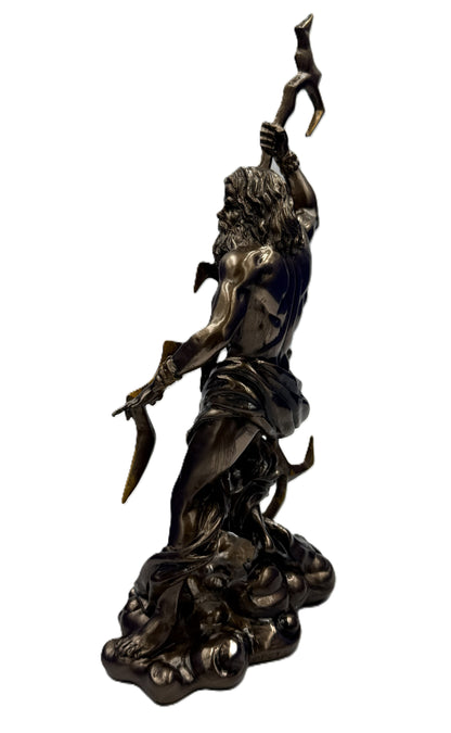 Side view of Zeus mythology statue showing dynamic pose with lightning bolt and flowing cloth in antique bronze finish
